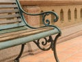 Closeup empty vintage bench in front of rugged wall Royalty Free Stock Photo