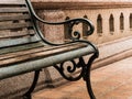 Closeup empty vintage bench in front of rugged wall Royalty Free Stock Photo
