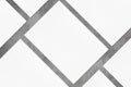 Closeup of empty white rectangle poster mockups lying diagonally on grey concrete background