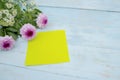 Closeup of empty yellow paper with gerbera flower Royalty Free Stock Photo