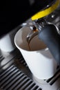 closeup espresso machine brewing coffee paper cup pour Royalty Free Stock Photo