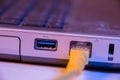 Closeup of Ethernet cable plug inserted into port on the side of Royalty Free Stock Photo