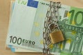 Closeup of euro banknote locked with chain and padlock - Stop cash concept Royalty Free Stock Photo