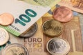 Closeup of Euros, coins and banknotes. One hundred Euro bill on top of two hundred Euro banknote. European central Bank currency Royalty Free Stock Photo