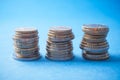 euros coins piles on blue background