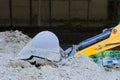 Closeup of excavator bucket on dusty ground