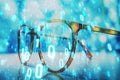 Closeup of eyeglasses with glowing binary digits overlay on blurred background. Concept of digital technology, cyberspace, and