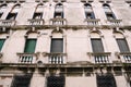 Closeup of the facade of a building, on the streets of Venice, Italy. White stone building with classic arched Venetian Royalty Free Stock Photo