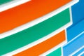 Closeup facade of concrete building. Orange, white, green, and blue building texture background with creative and beautiful