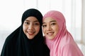 Closeup face. Asian Muslim women wear black and pink hijab. take portrait photo Indicates a happy smile in a white background