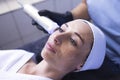 Closeup of face of beautiful relaxing girl undergoing hardware cosmetology procedure in spa