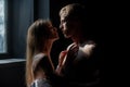 Closeup face of a beautiful young couple in love embracing in bedroom, romance and and affection. Royalty Free Stock Photo