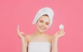 Closeup face of beautiful young smiling woman with bath towel on head. Beautiful woman face isolated on studio. Natural Royalty Free Stock Photo