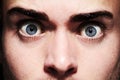 Closeup, face or eyes of shocked person with fear, terror and anxiety for schizophrenia or mental health. Man, stress or