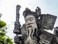 Closeup of the face of a historic, ancient Chinese stone sculpture statue of a Chinese warrior and in Wat Pho Buddhist Temple, Royalty Free Stock Photo