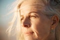 Closeup on the face of a mature woman on the beach. Beautiful senior woman enjoying the view on the beach. Face of a Royalty Free Stock Photo