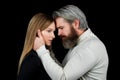Closeup face portrait of sensual couple. Young sexy couple in each other's arms on a black background. Royalty Free Stock Photo