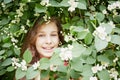 Closeup face of smiling little girl looks out