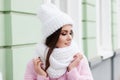 Closeup face of a young Smiling woman enjoying winter wearing knitted scarf and hat. Royalty Free Stock Photo