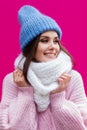 Closeup face of a young Smiling woman enjoying winter wearing knitted scarf and hat.