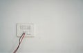 Closeup of a faceplate with cable wires mounted on a white wall Royalty Free Stock Photo