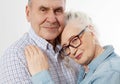 Closeup faces. Happy senior family couple isolated on white background. Close up portrait woman and man with wrinkled face.