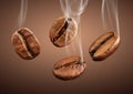 Closeup falling coffee beans with smoke on brown background