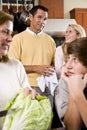 Closeup family in kitchen looking at each other Royalty Free Stock Photo