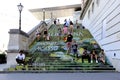 closeup of the famous exterior stairs of the Albertina exhibition area. people sitting on the steps.