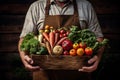 closeup of a farmer\'s hands holding a wooden box with organic vegetables Royalty Free Stock Photo