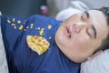 Fat man sleeping while junk foods scattered around Royalty Free Stock Photo