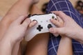 Closeup father and daughter hands with joystick play video game.