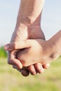 closeup Father holds daughter\'s hand on blurred nature background, outdoor. Trust, care