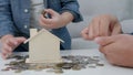 closeup father teaching son for keep money coin into piggy bank for saving money. wealth, Finance, business, investment,