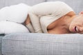 Closeup on feeling bad young woman laying on sofa