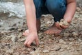 feet of child playing on the beach with stone Royalty Free Stock Photo