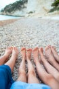 Closeup of the feet of family on the white sandy beach Royalty Free Stock Photo