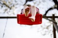 Closeup of feet of little toddler girl having fun on swing in domestic garden. Small child swinging under blooming trees Royalty Free Stock Photo