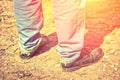 Closeup of feet of a man in old blue jeans and worn-out shoes. T Royalty Free Stock Photo