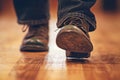 closeup of feet performing irish stepdance in hard shoes on wood floor