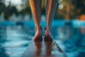 closeup of feet poised to jump off the end of a diving board Royalty Free Stock Photo