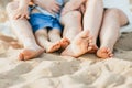 Closeup of feet row lying in line at summer beach Royalty Free Stock Photo