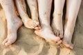 Closeup of feet row lying in line at summer beach Royalty Free Stock Photo