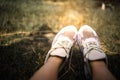 Closeup Of Feet In White Sneakers On Grass. Relaxation And Outdoor Idea Concept. Royalty Free Stock Photo