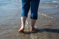 feet of woman walking in the water in the sea Royalty Free Stock Photo