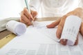 Closeup of female accountant looking through the receipts