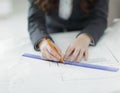 Closeup.female architect working with blueprints in the office Royalty Free Stock Photo