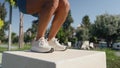 Closeup of female athlete doing jump training outdoors, fatburning plyometric exercise