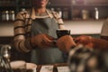 Smiling African barista giving her customer a fresh cappuccino Royalty Free Stock Photo