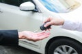 Closeup of a female car owner giving car keys from the car dealer. Royalty Free Stock Photo